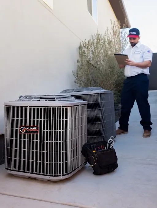 Climate Control AC technician servicing an air conditioning unit